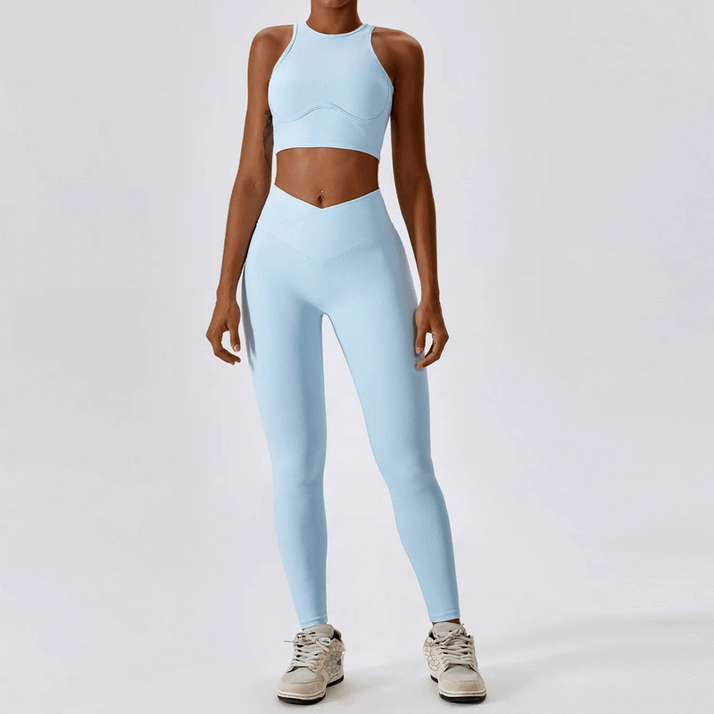Woman wearing blue push-up sports bra and ribbed cross leggings for active lifestyle.